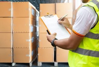 stock-photo-warehouse-inventory-management-courier-shipment-transportation-stack-of-cardboard-boxes-on-wooden-1390646237-transformed